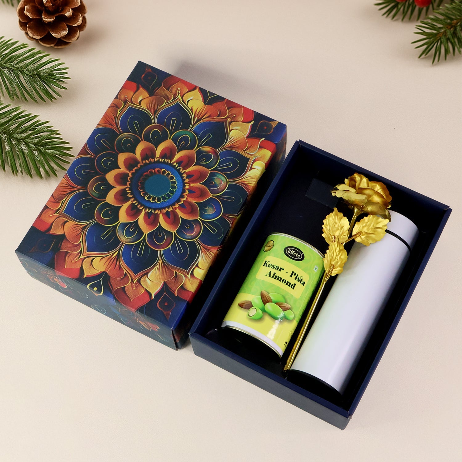 Festive kesar pista almonds gift hamper with golden rose and stainless steel bottle.