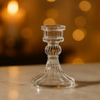 Elegant crystal glass candle holder stand casting a warm glow