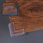 Close-up of a transparent silicone baby corner protector installed on a wooden table.