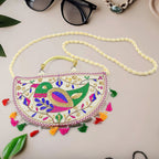 Vibrant Rajasthani Handbag with intricate multi-color embroidery on a light background.