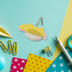 A cute bear-shaped self-adhesive hook on a wall, showcasing its strong adhesive backing for easy application.