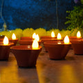 Water Sensor Diyas glowing warmly in a festive Diwali setup.