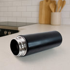 Side view of ergonomic stainless steel sports water bottle with flip-top lid