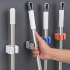Laundry room with wall-mounted broom holder for cleaning supplies