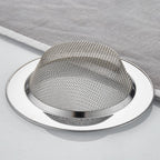 Side view of stainless steel dome-shaped drain hair catcher