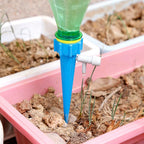 Close-up of the adjustable flow control valve on a plant watering spike.