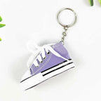 Miniature high-top basketball shoe keychain with black laces.