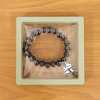 Multicolor pastel bead stretch bracelet shown with vibrant glossy beads and charm