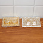Hands holding the ornate rectangular pooja thali with flower-lid kumkum box
