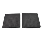 Four round felt pads applied under the legs of a wooden chair on a dark floor.