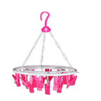 Multicolour round drying stand with 24 clips for efficient garment drying.