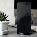A smartphone securely mounted in the PHOBIA Car Vent Mobile Holder inside a car.