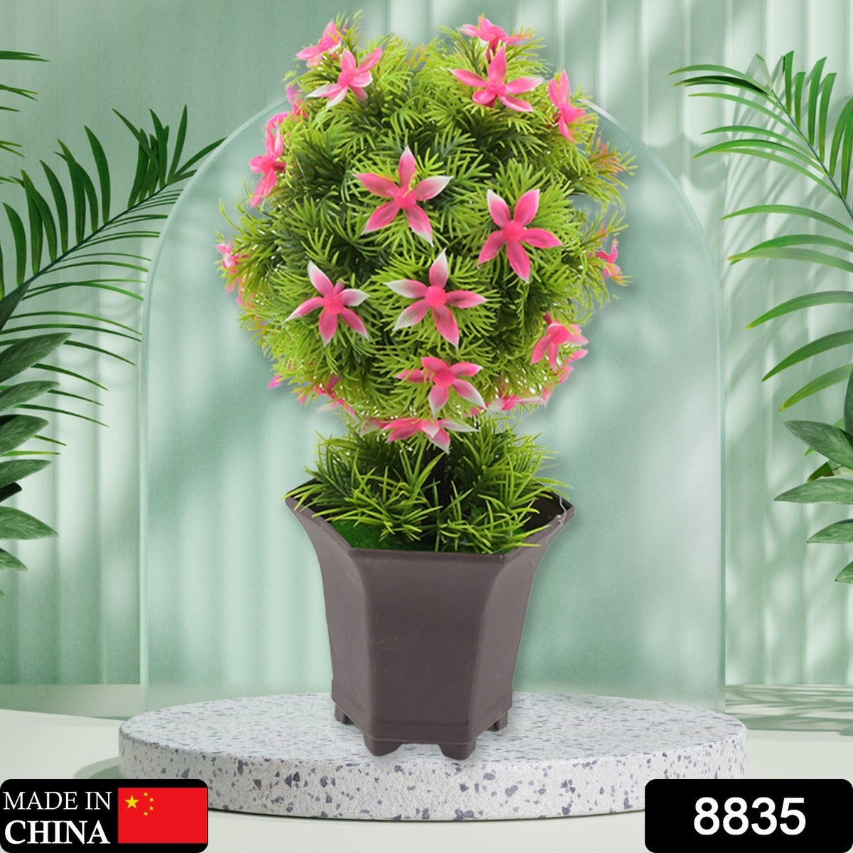 Close-up of the realistic green leaves and delicate flowers of the artificial plant.