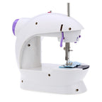 Close-up of the mini sewing machine's needle and thread for fabric stitching.