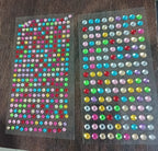 Brightly shimmering self-adhesive decorative shining stone stickers on display.
