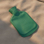 Hot water bottle providing warmth for muscle and joint pain relief