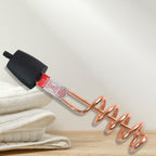 Close-up of copper heating element and insulated handle of water heater rod