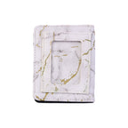 Compact card holder wallet featuring marble texture and snap closure