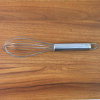 Small stainless steel balloon whisk on white background
