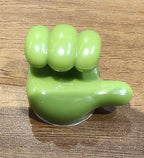 Angled view of the green hand-shaped flexible wall clip holder